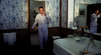 Movie still from “Teorema” (1968), directed by Pier Paolo Pasolini – A man standing in front of a mirror in a bathroom; Medium shot, High angle