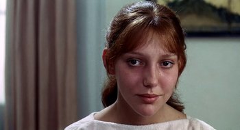 Movie still from “Teorema” (1968), directed by Pier Paolo Pasolini – A young woman with a red hair and blue eyes looking at the camera; Close Up shot, Over the shoulder angle