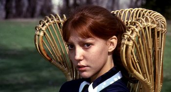 Movie still from “Teorema” (1968), directed by Pier Paolo Pasolini – A young woman sitting in a chair with a lot of bamboo; Close Up shot, High angle