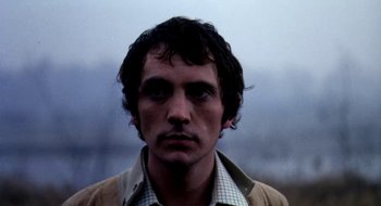 Movie still from “Teorema” (1968), directed by Pier Paolo Pasolini – A person wearing a jacket; Close Up shot, Low angle