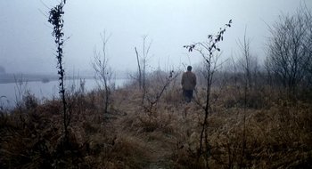 Movie still from “Teorema” (1968), directed by Pier Paolo Pasolini – A man standing in the middle of a dry grass field; Extreme Wide shot, Low angle