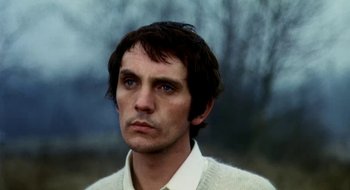 Movie still from “Teorema” (1968), directed by Pier Paolo Pasolini – A person wearing a white shirt; Close Up shot, Low angle