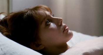 Movie still from “Teorema” (1968), directed by Pier Paolo Pasolini – A person laying on a bed; Close Up shot, High angle