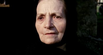 Movie still from “Teorema” (1968), directed by Pier Paolo Pasolini – An old woman with a black scarf on her head; Close Up shot, High angle