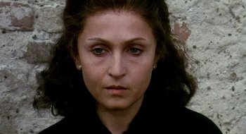 Movie still from “Teorema” (1968), directed by Pier Paolo Pasolini – A person wearing a black shirt; Close Up shot, High angle