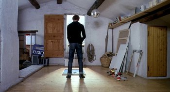 Movie still from “Teorema” (1968), directed by Pier Paolo Pasolini – A man standing in a room looking at something on the floor; Wide shot, Low angle