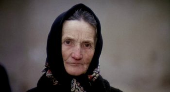 Movie still from “Teorema” (1968), directed by Pier Paolo Pasolini – An older woman wearing a black head scarf; Close Up shot, High angle