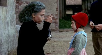 Movie still from “Teorema” (1968), directed by Pier Paolo Pasolini – An older woman and a young child looking at each other; Medium shot, Over the shoulder angle