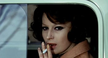 Movie still from “Teorema” (1968), directed by Pier Paolo Pasolini – A woman is smoking a cigarette in a car; Close Up shot, Low angle