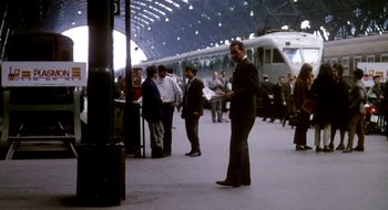 Movie still from “Teorema” (1968), directed by Pier Paolo Pasolini – A group of people standing in a train station; Wide shot, Low angle