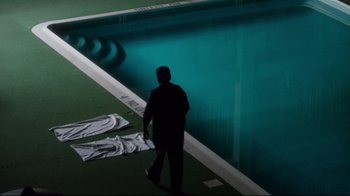 Movie still from “Tequila Sunrise” (1988), directed by Robert Towne – A man standing in front of a swimming pool; Extreme Wide shot, High angle