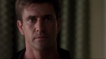 Movie still from “Tequila Sunrise” (1988), directed by Robert Towne – A person wearing a black shirt; Close Up shot, Low angle