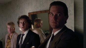 Movie still from “Tequila Sunrise” (1988), directed by Robert Towne – Two men wearing suits and ties in a room; Close Up shot, Over the shoulder angle