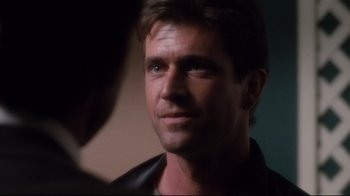 Movie still from “Tequila Sunrise” (1988), directed by Robert Towne – A person wearing a leather jacket; Close Up shot, Over the shoulder angle