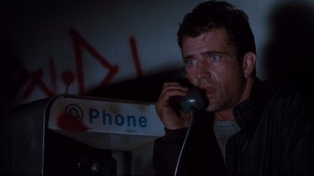 Movie still from “Tequila Sunrise” (1988), directed by Robert Towne – A man talking on a phone in a dark room; Close Up shot, Low angle