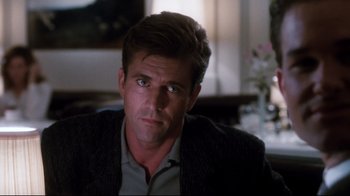 Movie still from “Tequila Sunrise” (1988), directed by Robert Towne – A person sitting in a room; Close Up shot, Over the shoulder angle