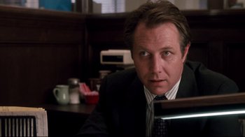 Movie still from “Tequila Sunrise” (1988), directed by Robert Towne – A person wearing a suit and tie; Close Up shot, Low angle