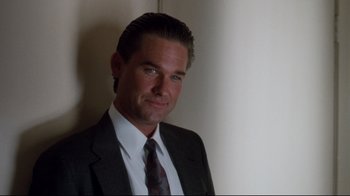 Movie still from “Tequila Sunrise” (1988), directed by Robert Towne – A person wearing a suit and tie; Close Up shot, Low angle