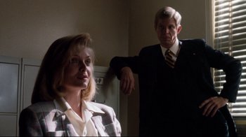 Movie still from “Tequila Sunrise” (1988), directed by Robert Towne – A man and a woman standing next to each other in a room; Medium shot, Low angle