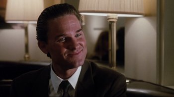 Movie still from “Tequila Sunrise” (1988), directed by Robert Towne – A person wearing a suit and tie; Close Up shot, Low angle