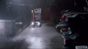 Movie still from “Tequila Sunrise” (1988), directed by Robert Towne – A car is parked in a parking garage in the rain; Extreme Wide shot, High angle