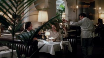 Movie still from “Tequila Sunrise” (1988), directed by Robert Towne – A group of people sitting at a table in a restaurant; Wide shot, Over the shoulder angle