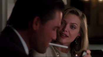 Movie still from “Tequila Sunrise” (1988), directed by Robert Towne – A man and a woman sitting at a dinner table; Close Up shot, Over the shoulder angle