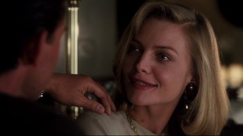 Movie still from “Tequila Sunrise” (1988), directed by Robert Towne – A woman is smiling while a man is touching her hair; Close Up shot, Over the shoulder angle