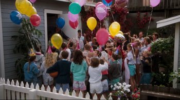 Movie still from “Tequila Sunrise” (1988), directed by Robert Towne – A group of people standing in front of a house with balloons; Wide shot, High angle