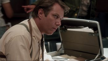 Movie still from “Tequila Sunrise” (1988), directed by Robert Towne – A man sitting at a desk in front of a computer; Close Up shot, Low angle