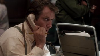 Movie still from “Tequila Sunrise” (1988), directed by Robert Towne – A man is talking on a phone while sitting at a computer; Close Up shot, Low angle