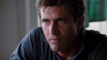 Movie still from “Tequila Sunrise” (1988), directed by Robert Towne – A person looking at the camera; Close Up shot, Low angle