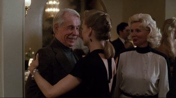 Movie still from “Tequila Sunrise” (1988), directed by Robert Towne – A man and a woman dancing together at a party; Medium shot, Over the shoulder angle