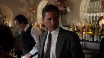 Movie still from “Tequila Sunrise” (1988), directed by Robert Towne – A man wearing a suit and tie in a room; Close Up shot, Low angle