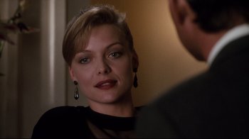 Movie still from “Tequila Sunrise” (1988), directed by Robert Towne – A woman in a black dress looking at a man in a suit; Close Up shot, Over the shoulder angle