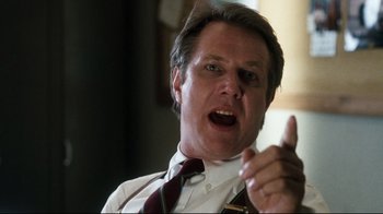 Movie still from “Tequila Sunrise” (1988), directed by Robert Towne – A person wearing a suit and tie; Close Up shot, Low angle