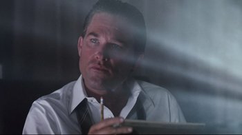 Movie still from “Tequila Sunrise” (1988), directed by Robert Towne – A person holding a cigarette; Close Up shot, Low angle