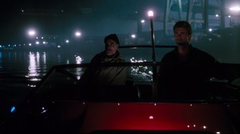 Movie still from “Tequila Sunrise” (1988), directed by Robert Towne – Two men sitting in a boat at night; Wide shot, High angle