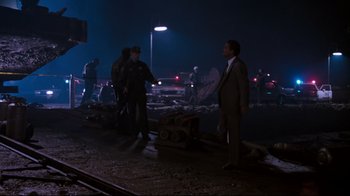 Movie still from “Tequila Sunrise” (1988), directed by Robert Towne – A group of men standing on the side of a road; Wide shot, High angle