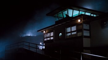 Movie still from “Tequila Sunrise” (1988), directed by Robert Towne – A night time view of a building with lights on; Extreme Wide shot, Low angle