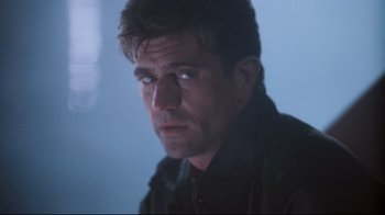 Movie still from “Tequila Sunrise” (1988), directed by Robert Towne – A person wearing a black jacket; Close Up shot, Low angle