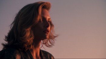 Movie still from “Tequila Sunrise” (1988), directed by Robert Towne – A person with long blonde hair; Close Up shot, Low angle