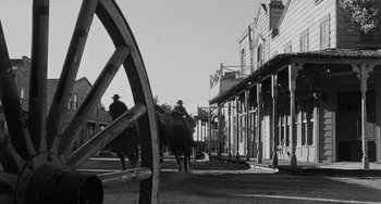 Movie still from “Terror in a Texas Town” (1958), directed by Joseph H. Lewis – Two men on horseback in a town square; Wide shot, Low angle