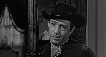 Movie still from “Terror in a Texas Town” (1958), directed by Joseph H. Lewis – A black and white photo of a man wearing a cowboy hat; Close Up shot, Over the shoulder angle