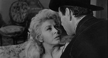 Movie still from “Terror in a Texas Town” (1958), directed by Joseph H. Lewis – An old photo of a man and a woman looking at each other; Close Up shot, Low angle