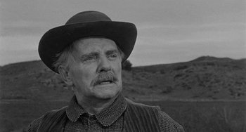 Movie still from “Terror in a Texas Town” (1958), directed by Joseph H. Lewis – An older man wearing a hat and a vest; Close Up shot, Low angle