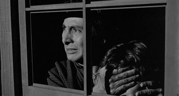 Movie still from “Terror in a Texas Town” (1958), directed by Joseph H. Lewis – An older man and a young woman looking out a window; Close Up shot, Over the shoulder angle