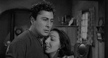 Movie still from “Terror in a Texas Town” (1958), directed by Joseph H. Lewis – A black and white photo of a man and a woman hugging; Close Up shot, Low angle
