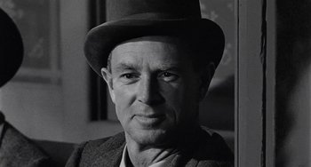 Movie still from “Terror in a Texas Town” (1958), directed by Joseph H. Lewis – An older man wearing a hat and a suit; Close Up shot, Low angle