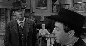 Movie still from “Terror in a Texas Town” (1958), directed by Joseph H. Lewis – Two men and a woman in a room; Medium shot, Over the shoulder angle